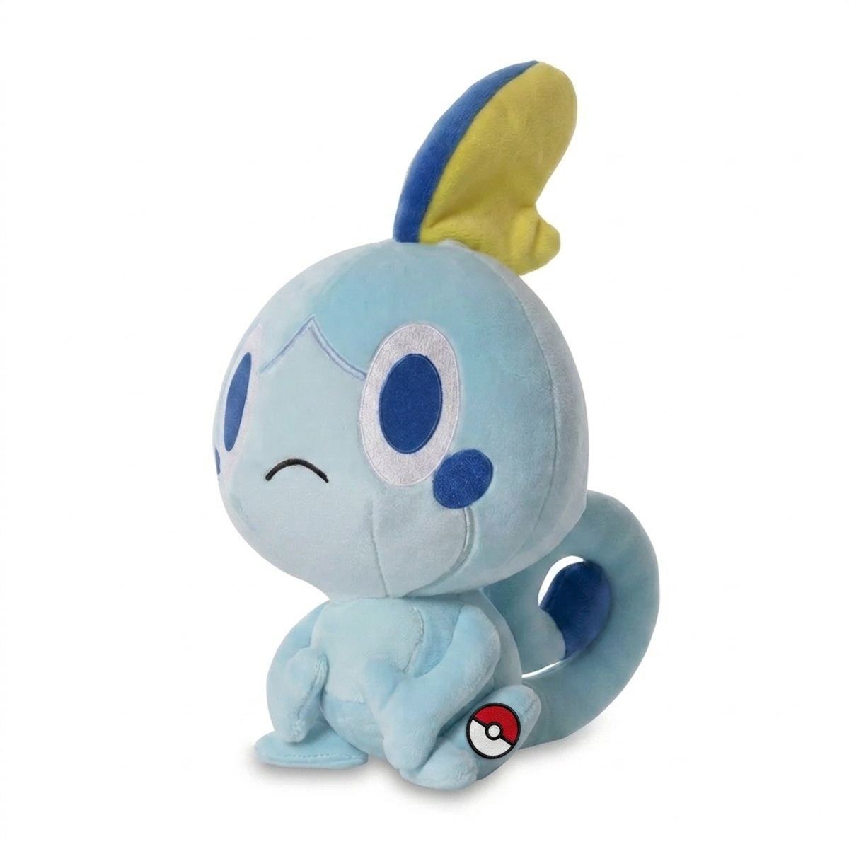 Peluche Larméléon avec badge prouvant l'authenticité du produit.