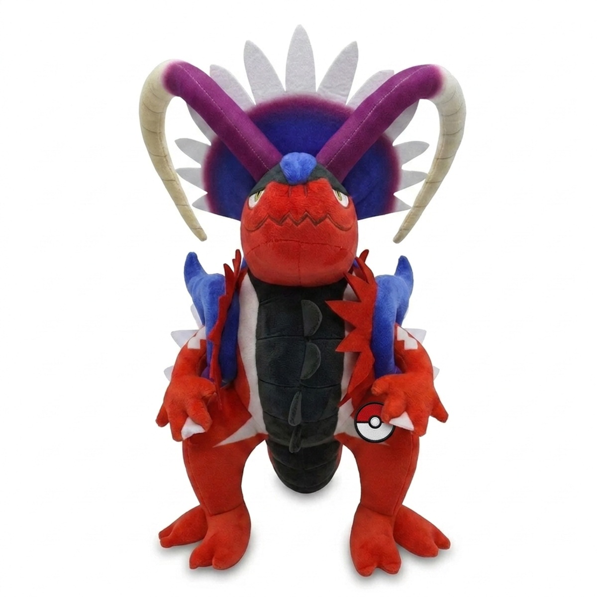 Peluche Koraidon avec badge prouvant l'authenticité du produit.